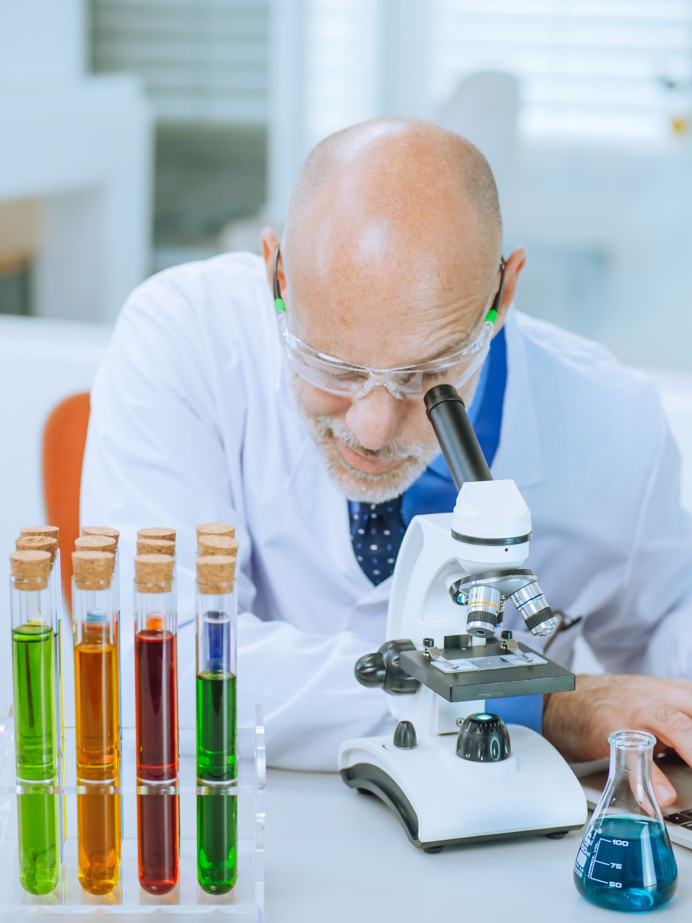 Scientist examining samples with analytical laboratory equipment